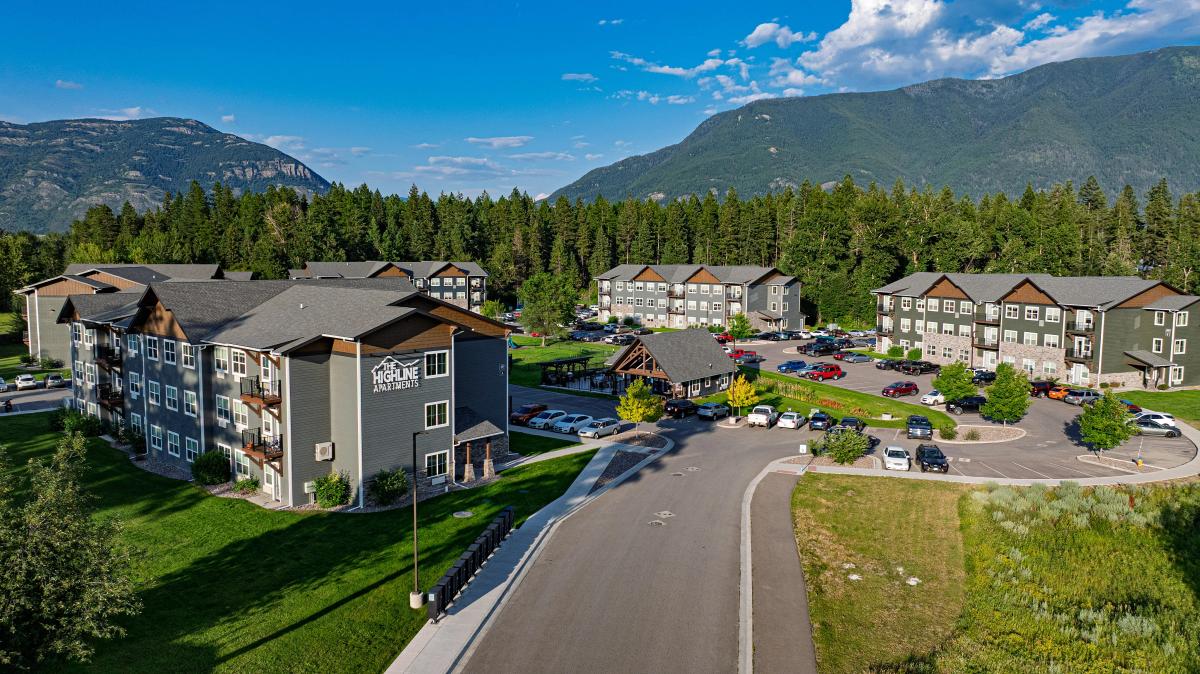 Charming apartment complex nestled amidst lush greenery with scenic mountain views